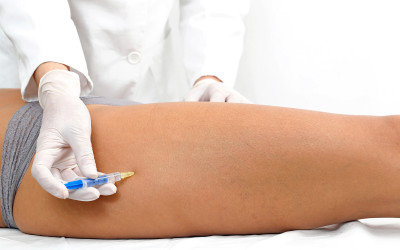 Woman having leg botox treatment at beauty clinic